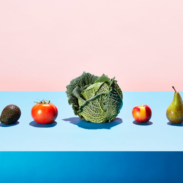 a row of different fruits and vegetables on a table top